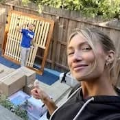 Happy Lugg customer watches as her movers disassemble bed frame