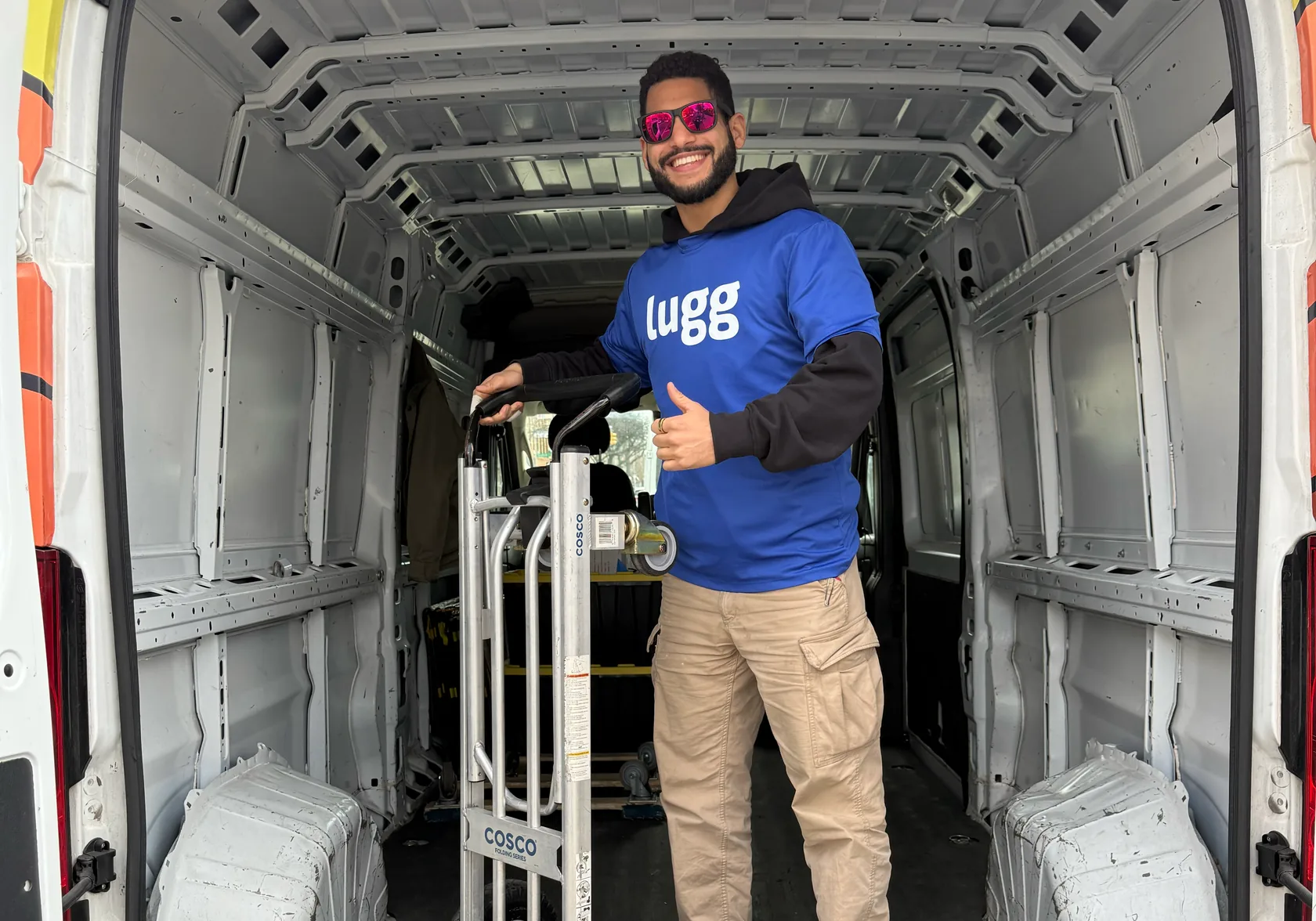 Lugger with a loaded hand truck in the back of a Lugg van