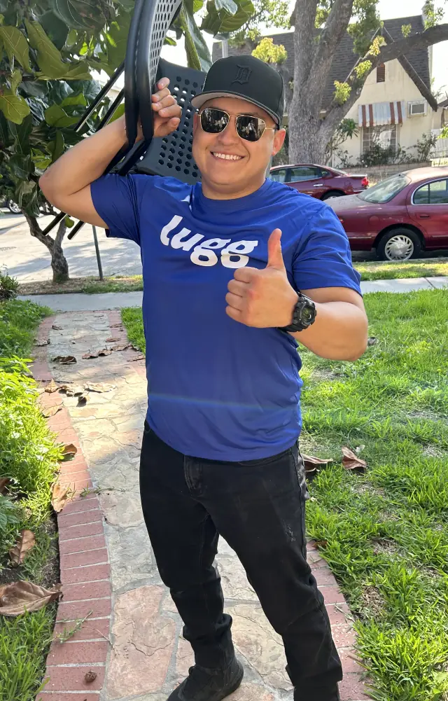 Lugger carrying a chair and giving a thumbs up