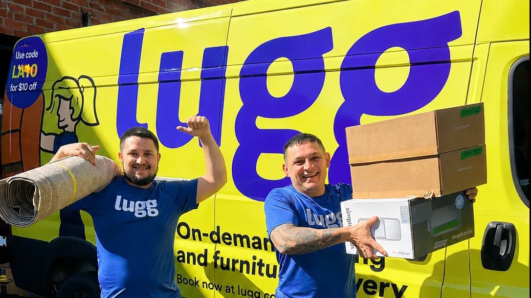 Two Luggers carrying a rug and boxes in front of a yellow Lugg van