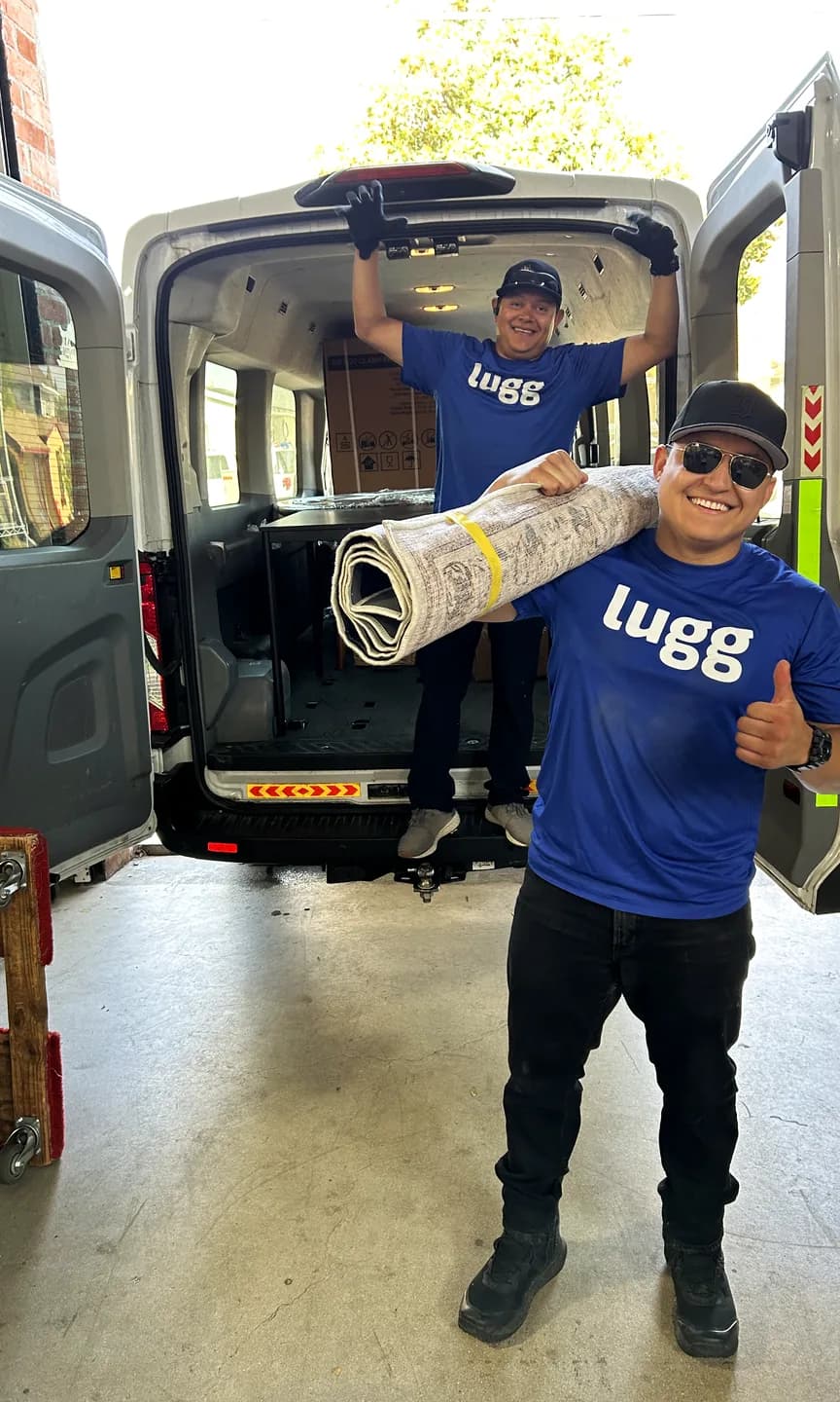 Two Luggers unloading a rug from a van