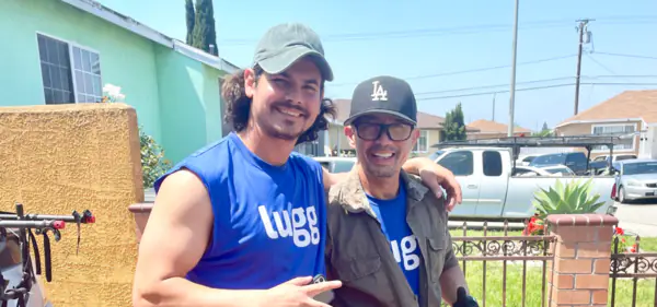 Two Luggers smiling in a driveway after a job
