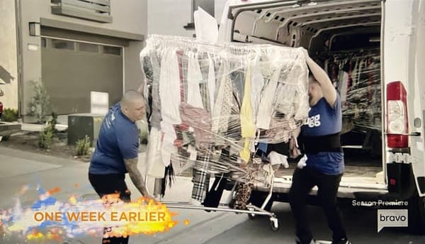 Two Lugg movers carry Gina Kirschenheiter’s clothing rack (wrapped for safe transport) out of a Lugg moving van during her move on The Real Housewives of Orange County Season 19 premiere. 