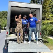 Luggers and customer in moving truck