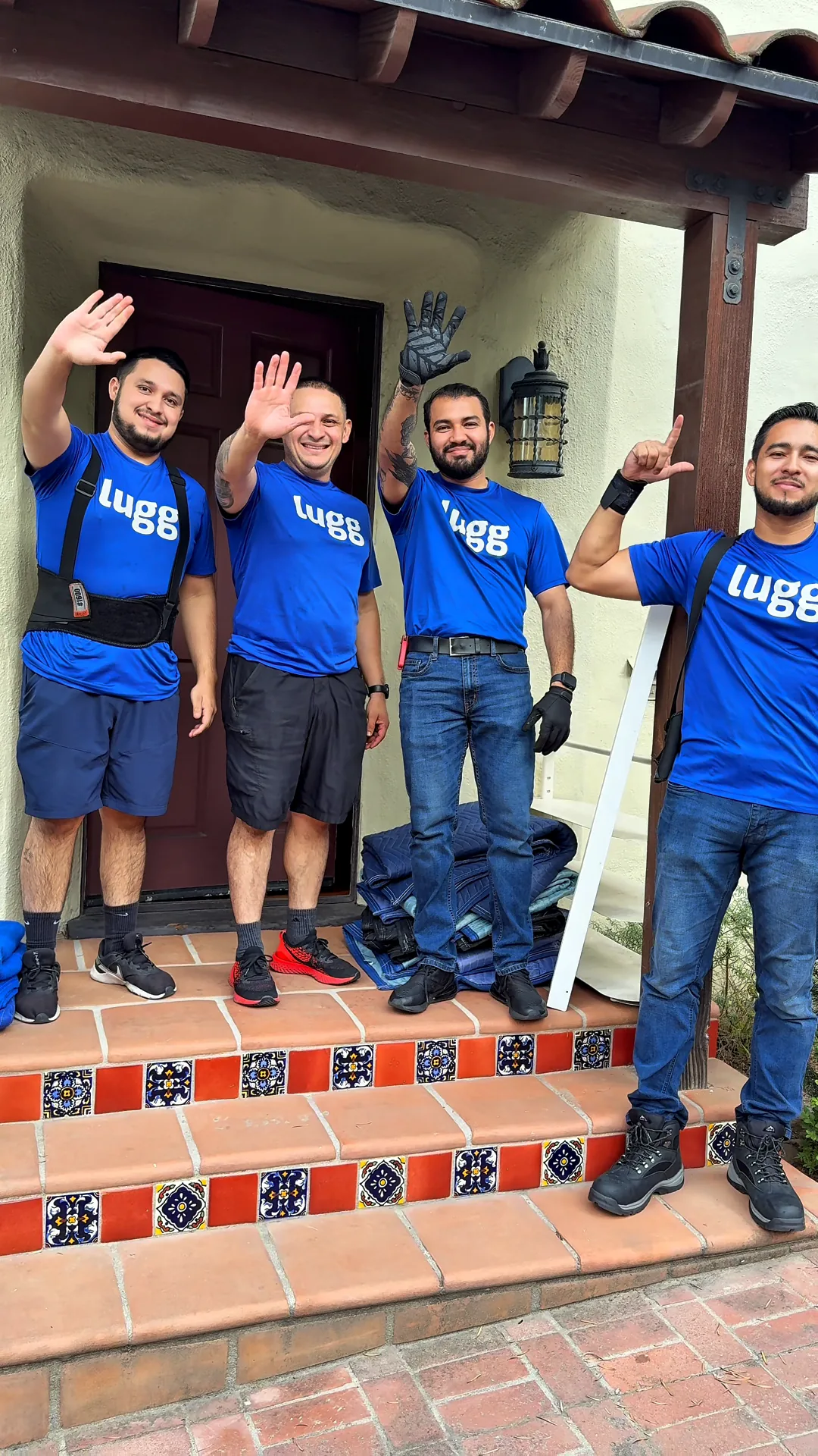 Crew of four Luggers waving on a front porch
