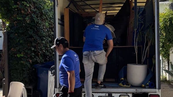 Lugg movers loading large items into a box truck, showing the largest Lugg vehicle option.
