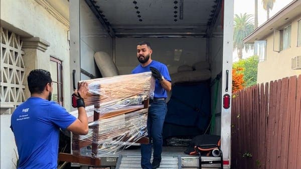 Lugg movers loading wrapped furniture into a box truck, a full-service alternative to renting a U-Haul.