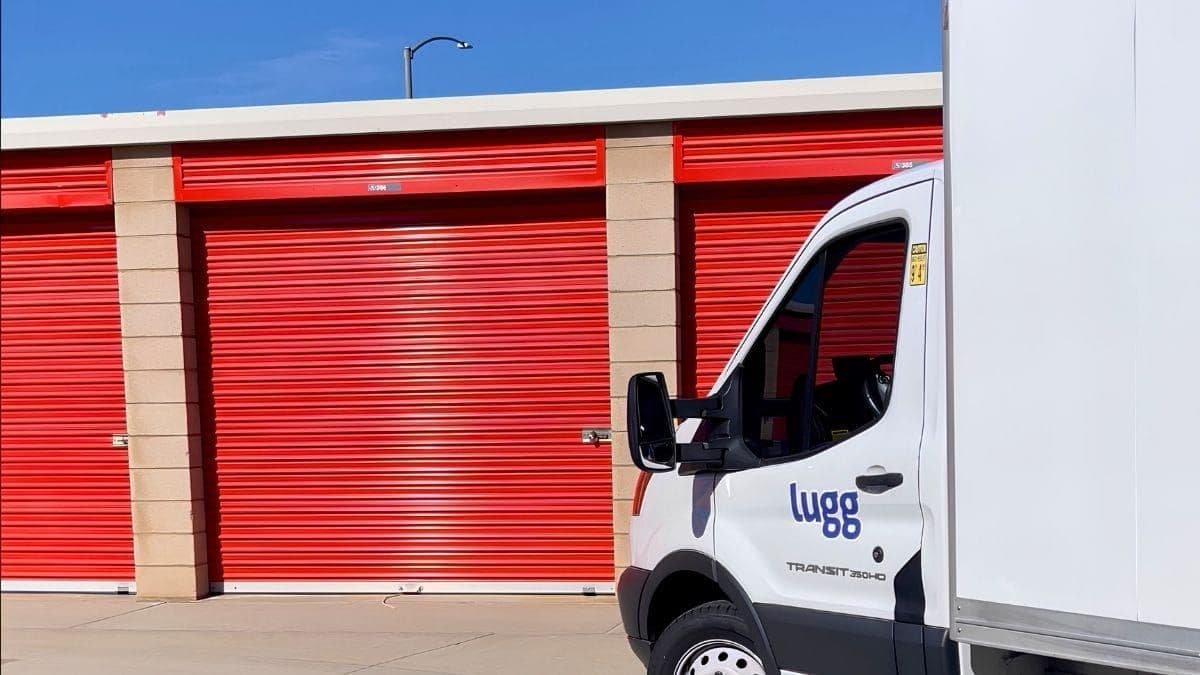 Lugg box truck parked at a row of self-storage units, ready for a storage facility move-in service