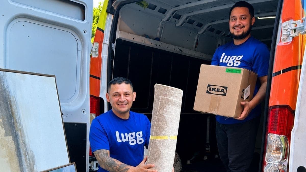Two Lugg movers loading boxes, including an IKEA furniture box, into a cargo van
