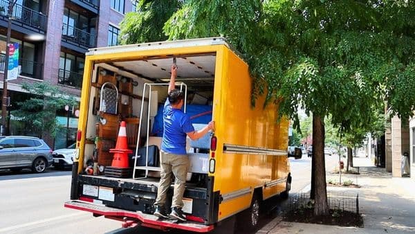 Lugg mover closing a fully loaded box truck on a city street